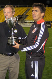 Jaime Moreno accepts United's first Coffee Pot Trophy, via behindthebadge.com