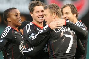 Adam Cristman celebrates his two goal performance with his teammates.  Photo via dcunited.com