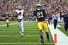 Michigan wide receiver Junior Hemingway (21) crosses the goal line to score a touchdown in front of  Illinois linebacker Martez Wilson (2) during the second quarter of an NCAA college football game, Saturday, Nov. 6, 2010, in Ann Arbor, Mich. (AP Photo/Tony Ding)